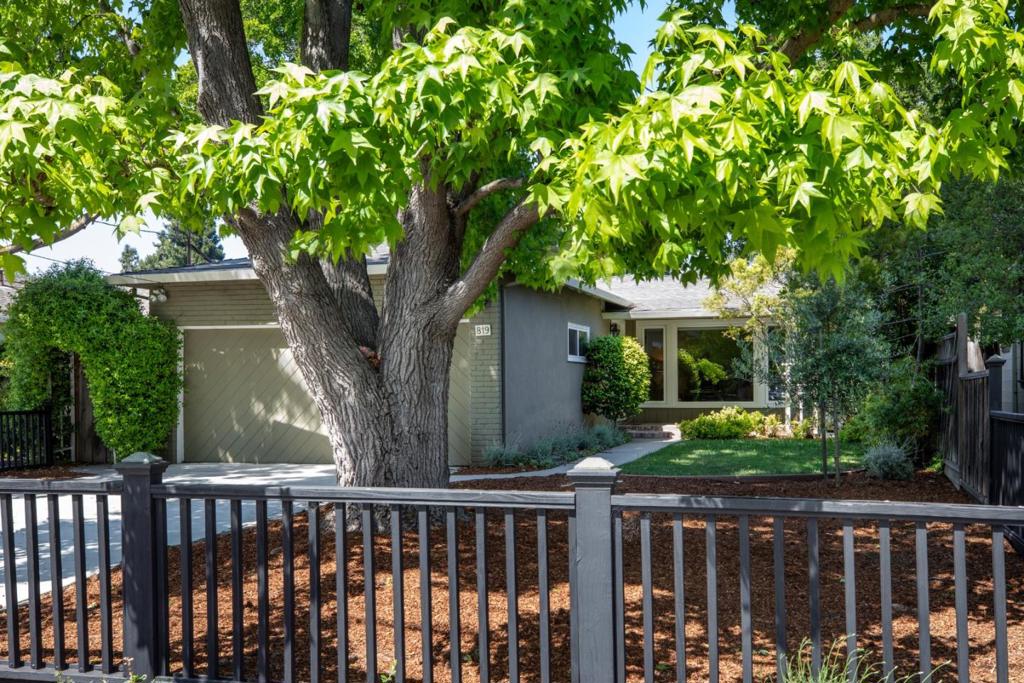 Maintained sweet home in Menlo Parks sought-after Willows neighborhood with excellent schools and conveniently located. Welcoming front porch and timeless curb appeal lead to a spacious living room with beamed ceiling, gas brick fireplace, built-in bookcases, and large picture window. Hardwood floors throughout living areas and bedrooms. Remodeled, open concept, kitchen features quartz counters, tile backsplash, dark wood cabinetry, island seating, breakfast nook, and stainless steel appliances including Bosch dishwasher and Samsung fridge. Primary suite with updated bath, tiled shower, and glass enclosure. Hall bath with tub/shower combo. Additional highlights include recessed lighting, dual-pane windows, and a large laundry room with stacked washer/dryer and backyard access. Converted 2-car garage offers bonus space (permit unknown) perfect for recreation room, guest, office or gym. Spacious backyard with paver patio, vast lawn, built-in BBQ, and detached structure with electricity perfect for office. Located near top-rated Menlo Park schools, parks, and major commute routes including Hwy 101.