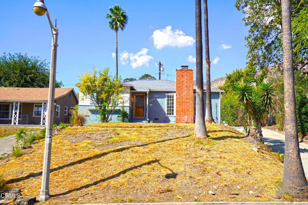 First time on the market in 59 years, this 1948 Traditional home presents a rare investment opportunity with endless potential to reimagine and add value. The property offers three spacious bedrooms, two bathrooms, and a 21' x 15' office/bonus room. The expansive living room features a classic masonry fireplace and large windows that flood the space with natural light, while the adjacent formal dining room and kitchen with breakfast nook create a functional layout ready for modernization. The backyard offers excellent usability with brick pavers on one level and a grassy area on the second level, complemented by a detached two-car garage at the rear of the property--perfect for additional development possibilities such as an ADU (buyer to verify). Recent upgrades include new vinyl plank flooring and new insulation, leaving cosmetic renovations as the next step to maximize return. This is an exceptional opportunity for investors, developers, or owner users to capitalize on a home with strong fundamentals, a generous lot, and versatile spaces. Assessor's records indicate 1,554 square feet, while measured interior square footage is 1,910 (buyer to verify permits).
