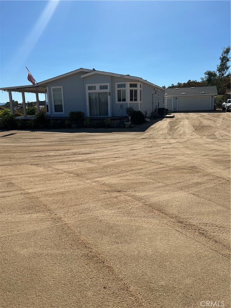 Quality-Built Home with Stunning Lake Views in Lake Riverside Estates
Tucked away at the end of a quiet cul-de-sac, this beautifully crafted 1,830 sq. ft. manufactured home blends comfort, quality, and breathtaking scenery in the desirable Lake Riverside Estates community. With 3 bedrooms, 2.5 baths, and a thoughtful layout, this home offers both everyday convenience and luxurious touches.
Inside, you’ll find elegant crown molding throughout, cherry wood cabinets that reach to the ceiling, stainless steel appliances, and a well-designed indoor laundry with built-in features. The spacious master suite is a true retreat, offering plenty of room to relax. From the kitchen window, enjoy peaceful mountain views, while expansive windows highlight the property’s spectacular lake vistas.
Outdoors, the property is equally impressive. A 3-car garage, upgraded 220-amp electrical panel, and sprinkler system add modern functionality. The grounds have been meticulously maintained and cleared for fire safety, while more than 70 fruit trees create a lush and productive landscape.
Living in Lake Riverside Estates means access to a host of amenities designed for both relaxation and recreation. Residents enjoy a private lake with picnic areas, scenic walking trails, a tot lot, equestrian arena, round pen, and even a private 3,600 ft. lighted airstrip. With Cal Fire located directly inside the community gates, safety and peace of mind come built in.
Only 25 minutes from Temecula’s renowned shopping, dining, and wine country, and close to Anza’s local conveniences including restaurants, hardware stores, schools, and more, this home offers the perfect balance of country charm and accessibility.
Move-in ready and attractively priced, this property is a rare opportunity to enjoy the very best of Lake Riverside living.