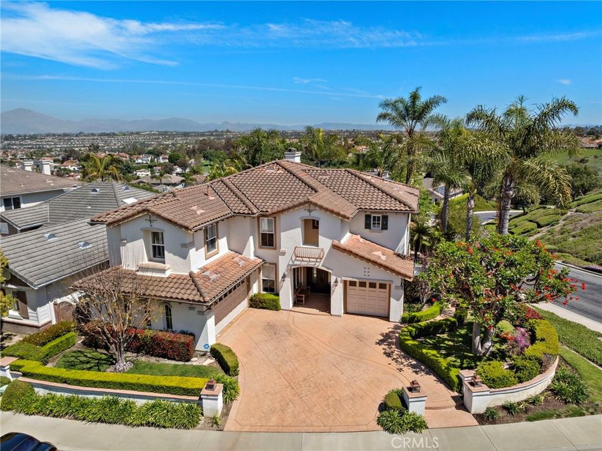 This stunning hilltop estate is set on an expansive 11,000 sq. ft. corner lot in the exclusive, guard-gated community of Hillcrest Estates. Just minutes from the coast, it showcases panoramic Tuscan hill and mountain views, offering the essence of luxurious coastal living. A dramatic 20-foot foyer welcomes you inside, where marble and wood flooring, elegant finishes, and walls of windows fill the home with natural light. Spanning 3,840 sq. ft., the thoughtfully designed layout includes 4 spacious bedrooms plus an optional 5th (currently a media room), 4.5 bathrooms, and 3 elegant fireplaces for warmth and ambiance. The chef’s kitchen is a showpiece, complete with a granite island wet bar, premium stainless steel appliances, and seamless flow into the oversized family room with stacked stone fireplace—ideal for both entertaining and everyday living. Step outdoors to a private resort-style retreat featuring a PebbleTec pool and spa, a 10-foot built-in BBQ island, fire pit, lush landscaping, and multiple lounge areas—perfect for gatherings or peaceful relaxation. The luxurious primary suite offers a private balcony with sweeping views, a cozy fireplace, and a spa-inspired bath with a soaking tub, walk-in shower, dual vanities, and travertine finishes. Additional highlights include: Main-level en suite bedroom, perfect for guests or multi-generational living. Formal dining room and entertainer’s living room with pool table. Minutes to world-class resorts, beaches, fine dining, shopping, award-winning schools, and outdoor trails. Convenient access to the 73 Toll Road and 5 Freeway. Available fully furnished or unfurnished. This estate combines elegance, privacy, and comfort with resort-style amenities and breathtaking vistas from nearly every room. Don’t miss the chance to lease this one-of-a-kind Laguna Niguel residence in one of its most prestigious communities.