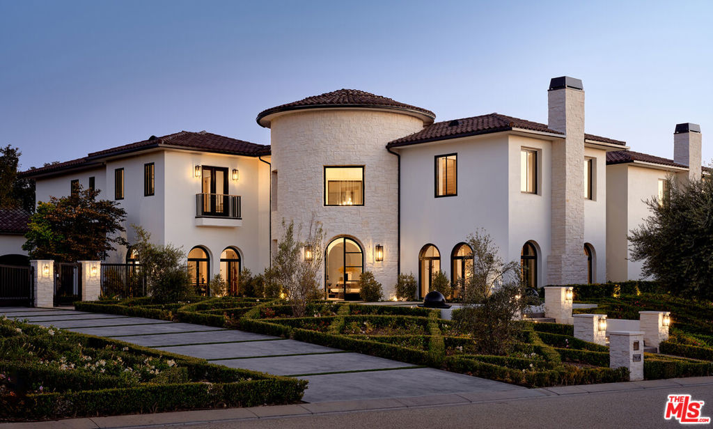 Behind double private gates of the exclusive Estates of the Oaks community, sits this majestic residence on a sprawling 1.14 acres of meticulously curated grounds including approx. 14,000+ SF of remarkably warm interiors, a detached guest house with full kitchen, sports court, expansive, grassy backyard and the highest caliber craftsmanship. Set at the end of a quiet cul-del-sac, this thoughtfully reimagined estate features soaring 30' ceilings upon entry, and grand living spaces bathed in natural light through beautifully arched picture windows and floor-to-ceiling doors. Elevated with bespoke detailing, finishes and amenities, with 7 bedrooms/9 baths, all equally as stunning as the next, with custom feature walls and elegant textures, luxuriously appointed bathrooms and private terraces. An adjoining open air courtyard, tranquil outdoor covered patio, spectacular dining rooms, and the most incredible sunken poolside fireplace lounge - make for one of a kind entertaining areas, along with the home theater and putting green. With a seamless open floor plan. the home includes a brand new chef's kitchen with with top of the line appliances, large butler's pantry with caterer's kitchen and big adjoining breakfast room, opening to the spacious family room with sliding walls of glass that overlook the grounds, plus a floor to ceiling fireplace, and adjacent, glass encased wine display with tasting lounge. Boasting a custom office, gym with sauna, and complemented throughout by herringbone oak flooring with herringbone accents, leading to six pristine suites, each with new baths. The primary suite offers sweeping mountain views, a fireplace, and a private patio deck, bath with glass-encased shower, dual vanities, and custom closets. A new guest house features a full kitchen, den, and sliding glass walls opening to a covered patio. The lush grounds include a sparkling pool, fire pit, basketball court, and putting green, all behind secure gates with garages for four cars.Within a coveted gated community, this home offers unmatched privacy and serene mountain vistas. Conveniently close to top schools, shopping, and Malibu's beaches, it epitomizes luxury living with thoughtful design and unparalleled attention to detail.