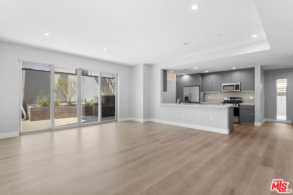 Welcome to this just-finished, contemporary-modern 1bed, 1 bath residence located in the heart of prime West Hollywood. Step into a beautifully designed unit where natural light floods through oversized windows, highlighting the sleek modern wood flooring and open-concept layout. The expansive living room flows seamlessly into a stunning kitchen featuring quartz countertops, modern cabinetry, and stainless steel appliancesincluding a dishwasher.Recessed lighting throughout enhances the clean, modern design, while the in-unit washer and dryer offer ultimate convenience. Both bedrooms are spacious with ample hanging and storage space. The bathrooms feature elegant modern finishes, including a beautifully tiled shower and excellent lighting.Additional perks include generous pantry and closet storage, plus covered parking. Be among the first to live in this brand-new buildingschedule a tour before these exceptional units are gone!