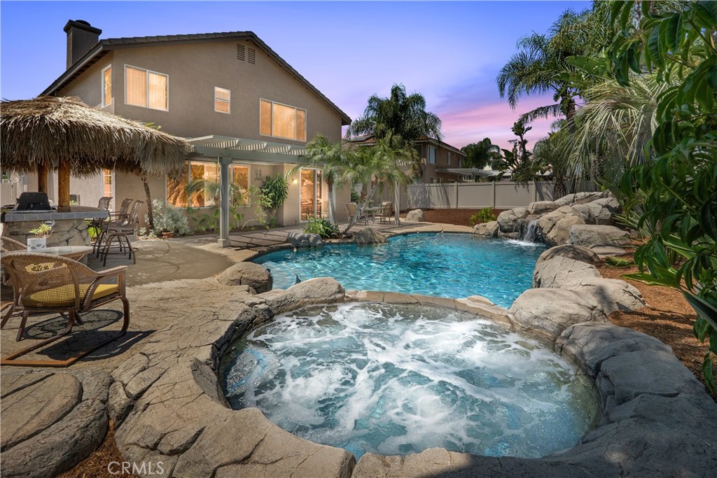 ORANGECREST – INCREDIBLE 5 BEDROOM POOL HOME WITH FULLY-PAID-OFF SOLAR SYSTEM OF 35 PANELS!! Run that AC as much as you'd like!! Located in one of Riverside’s most desired neighborhoods, this home is adorned in natural light and has an easy-flowing floor plan of 2,405 sqft with 5 bedrooms and 3 bathrooms on a 7,841 sqft lot. The downstairs offers formal living and dining rooms, a downstairs bedroom and full bathroom, and an efficient kitchen with lots of working counter space and dining area, which adjoins a large family room with gas fireplace. Completing the downstairs is a convenient laundry room with direct access to the garage. Upstairs features a spacious primary bedroom with an en suite primary bathroom with dual sinks, walk-in shower and soaking tub, and an enormous walk-in closet with substantial storage space. Three other well-proportioned bedrooms with ample closets share a hall bathroom with dual sinks. The backyard offers an incomparable entertaining setting with an inviting pool with grotto and spa, custom palapa covered BBQ island, an expansive covered patio perfect for guest dining or lounging, room for kids/pets to play and a sizeable storage shed. Both front and rear yards provide peaceful settings with covered seating areas and appealing landscaping. Other amenities include: high ceilings and ceiling fans throughout, dual pane windows and neutral blinds throughout, 3-car attached garage, fully irrigated yards, room for an RV, ADU potential, extra storage or more! This home is mere minutes from many amenities including shopping, schools, churches, and freeways. Meticulously maintained and ready for immediate move-in! NO HOA! LOW TAXES! NO MELLO ROOS!