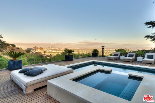 This custom-built home home has everything one could ask for- luxury, prestige and location. Set behind a gated enclave above the Sunset Strip, this 4 bd home features jetliner views, indoor-outdoor lifestyle on a 40,864 sq. ft. lot, with seamless access to the stunning pool and hot tub. This entertainer's home boasts a large, open living room with dramatic views, dining area plus chef's kitchen w/ top quality appliances throughout. Master ste has a fireplace, large drop down screen, luxurious bath, separate steam shower plus a large walk-in closet and opens up to a sundeck overlooking the city. The house boasts two additional bedrooms and 1 attached en-suite guest unit with separate entrance. Offered fully furnished.
