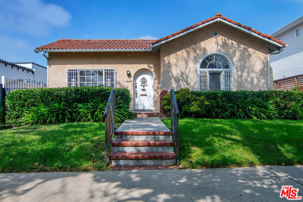First time on the market in 37 years!! Side-by-Side 1926 Spanish Character Duplex that's 2602 sq ft of living space on a 7357 sq ft lot DELIVERED VACANT AT THE CLOSE OF ESCROW in prime Miracle Mile location close to The Grove! Charming front porch, grassy line and classic Spanish clay tile roof make for nice curb appeal. Living room opens to the dining room perfect for entertaining. Large office with faux fireplace and picture window to street. Large kitchen with high ceilings, abundant cabinetry and countertop space, 2 sinks, dishwasher, stove/oven, and door to yard. Laundry off hallway. Full bath in hallway. Linen closet. 3 beds and 2 baths in owner's unit. Primary suite with walk-in closet and attached bath with tub/shower. 2 secondary beds, both with door to backyard, share full bath. Rear tenant unit has kitchen with breakfast area, 2 beds + 1 bath with shower/tub. 1 car garage + 2 hostel style guest rooms in yard, one with 1/2 bath and one with full bath. Can be converted back to original 2 units with 2 bedrooms each or remodeled and used as large owner's unit with smaller tenant unit. Hardwood floors, central HVAC, pleasant floor plan. Unusually large and spacious Spanish single story in prime location!