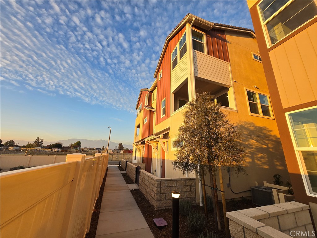 View! View! View! Feast your eyes on this **BRAND NEW, never-before-lived-in tri-level townhome** with a view so breathtaking, it's practically a work of art! Imagine waking up every morning in your primary bedroom or unwinding after a long day on your family room balcony, gazing out at the endless sky, the lush greenfield, and the picturesque community overlook. This isn't just a home; it's an escape, a sanctuary, and an opportunity to live a life of unparalleled beauty and tranquility. As an end unit, privacy and peace reign supreme. Step inside on the first floor, there is a spacious two-car garage and a convenient entryway that leads to ample storage space. Step up to the 2nd floor, discover a modern masterpiece, where a pure white countertop and cabinets dance with warm greyish-brown wood flooring, creating an inviting and stylish ambiance. The open-concept kitchen and family room are an entertainer's dream, while a convenient powder room adds a touch of practicality. On the 3rd floor, escape to your private oasis; two cozy bedrooms offer easy access to a full bath, while the primary bedroom boasts its own ensuite bathroom for ultimate relaxation. And with brand new appliances, including a refrigerator, dishwasher, range, washer, and dryer, you can move in and start living your best life from day one! But the luxury doesn't stop there! Enjoy access to a dazzling array of amenities, including a shimmering swimming pool and jacuzzi, a clubhouse, ball courts, a putting green, playgrounds, sprawling lawn areas, BBQ and entertainment spaces, and even fire pits for cozy evenings under the stars. Located in the heart of Eastvale**, you'll be close to everything you need, including the 15 freeway, shopping, restaurants, schools, and parks. **Don't miss your chance to be the first to experience the magic of this extraordinary home. Your dream life awaits! **