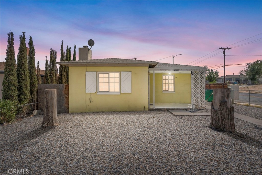 Cozy Charmer in Old Victorville. Small in size but big on personality, this 2-bedroom, 1-bath bungalow is ready for its next chapter! Recently refreshed, it blends vintage charm with practical updates. The living room features a classic brick fireplace, perfect for adding warmth and ambiance on chilly evenings. The kitchen keeps things simple and functional, while the adjacent utility room offers extra storage and laundry space. Outside, the fully fenced corner lot has alley access, room for a storage shed, and plenty of room for parking or a garden. With a quaint front porch, mature trees, and a location close to parks, schools, and Old Town’s shopping and dining, this little cutie makes everyday living easy and convenient.