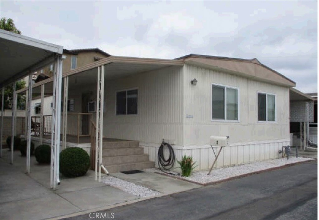 Don't Miss out on this one! Welcome to this spacious 3-bedroom, 1.75-bath double-wide manufactured home in the sought-after 55+ community of Park Villa Mobile Home Estates. Offering approximately 1,400 square feet of potential, this diamond in the rough is perfect for a buyer looking to customize their space. The home features a large living room, a spacious kitchen with newer gourmet stove/oven, hood and a breakfast area, a separate dining space, and a primary bedroom with an en-suite bathroom. Enjoy a private covered front porch, backyard area, and covered parking with ample guest parking nearby. Park Villa is a quiet, pride-of-ownership senior community offering a community pool, clubhouse, and garden area. Ideally located near the ocean, freeways, restaurants, parks, shopping, and top hospitals including UCLA Harbor, Kaiser, and Long Beach Memorial. Just a short drive from Downtown LA, LAX, SoFi Stadium, and other local attractions and entertainment. Plus rent control with guaranteed low space rent, this comfortable home offers affordability, convenience, and comfortable lifestyle — ready for your personal touch!