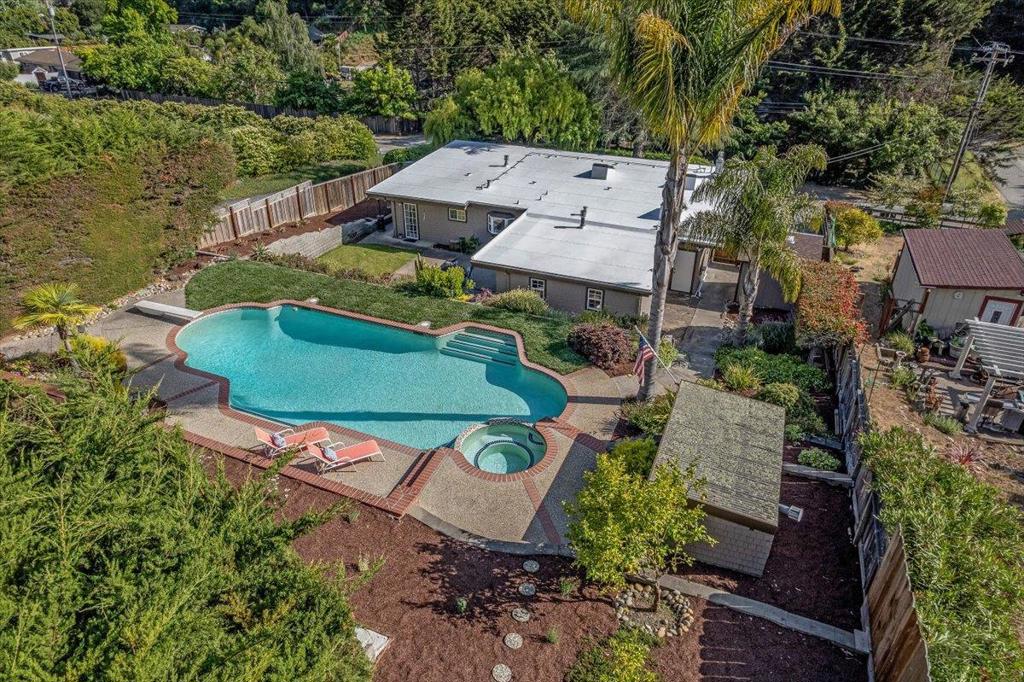 Welcome to your place in the sun! Located in the highly sought after Day Valley community of Aptos, Set on .27 acres, this property lives like a resort. This well kept single level home offers an open floor plan w/ an abundance of light & space to entertain. Open beam ceilings, skylights, kitchen w/ breakfast bar, large dining room that opens to an expansive living room w/ fireplace. Spacious primary suite w/ tile floors, gas FP stove and sitting area. Primary bath has double sinks, hydro soaking tub and double shower. Large indoor utility room w/ sink, pantry and an abundance of storage. All bedrooms enjoy glass doors leading to the patios. A magical, private retreat awaits you with a large backyard & expansive patio surrounded by lush landscaping and mature trees. Terracing takes you to the upper yard where the centerpiece is an inground pool sparkling pool & hot tub. This almost 12,000sf parcel, includes a lush sod lawn, horseshoe pit and a custom-built yoga studio. Enjoy ample space to host parties or just soak up the sun in your perfect private, poolside paradise. More than just a home, it's your own personal sanctuary. The peaceful lifestyle you've been dreaming of becomes your new reality! Just minutes from Hwy 1, Aptos Village and the beach. You'll love this property.