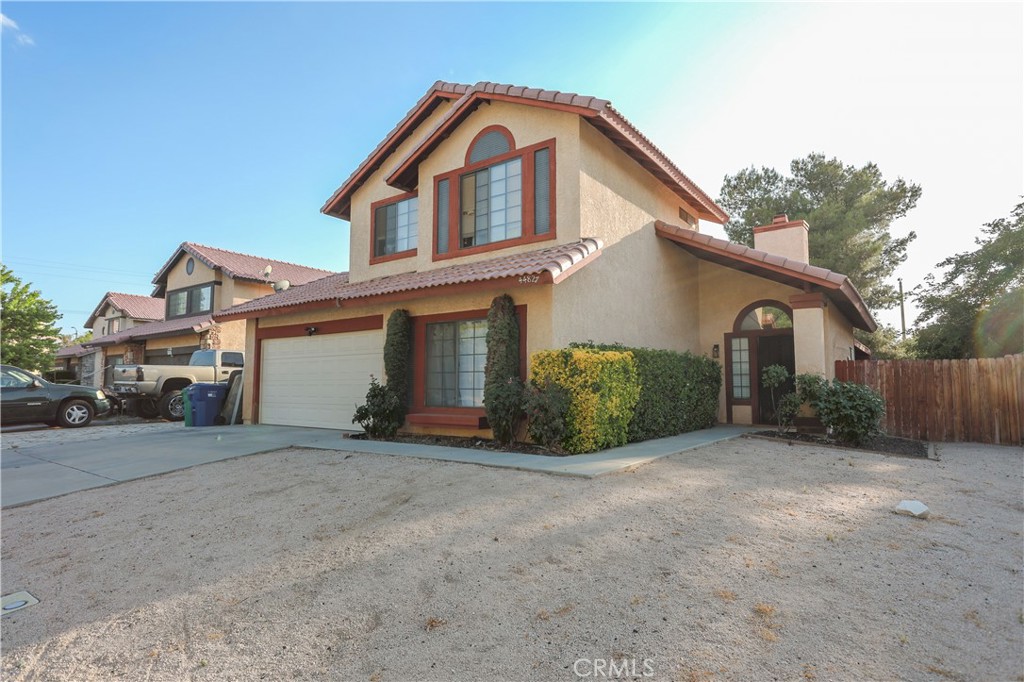 This property was under contract / escrow with former tenant, has never been shown until now - disregard any / all days on market! Walk into this gorgeous rehabbed home as you step into the large - spacious living room with high vaulted ceilings, new laminate flooring, fresh interior paint, attractive brick fireplace and plenty of high windows that contribute to a light and bright ambiance, step into the formal dining room with custom tile flooring, ceiling fan / light fixture - surrounded by windows allowing full back yard view, step into the spacious kitchen with range, oven, microwave and dishwasher, recessed lights and custom tile flooring make this kitchen just right, step into the designated laundry room with hot / cold water and 220 amp dryer / vent available, step into the extra spacious bonus downstairs room with direct access to the two car attached garage, make your way upstairs and appreciate the three spacious bedrooms upstairs and walk through the master bedroom with huge bathroom / shower all rooms are sporting new laminate flooring, fresh interior paint and new light fixtures throughout, finally step out to the massive back yard with covered patio, perfect to entertain or any other use of choice, this fine home is seeking a new homeowner to call it "Home Sweet Home"