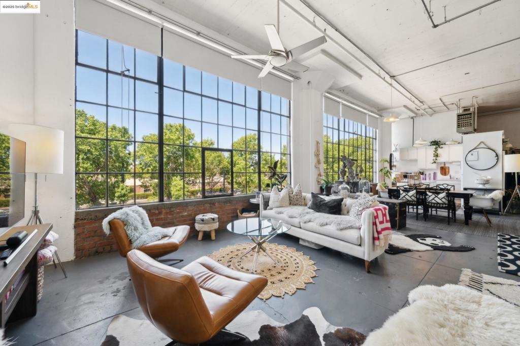 Boho Chic is on full display at the Besler Building in Emeryville. The second-floor suite is over 1100 SQF and located inside an amazing - formal industrial building. Suite 217 has soaring 14 foot ceilings and a wall of west facing windows. Keeping the interior naturally bright all day. Not to mention, truly epic sunsets. Spacious loft space abounds - big enough to hold plenty - yet flexible by design so one can have personalized areas within – dining area, living area and full kitchen with a gas stove and lots of cabinets. There is an updated bathroom with a walk-in stall shower, white penny tiles on the walls and handsome dark grey floor tile. The look is modern and sophisticated. Additional overhead storage is located above the bathroom. An impressive dressing area with substantial space - to be swooned over by clothes horses from near and far. Besler building hosts a truly creative community of artists, designers and working professionals – commingling in this truly unique building. Another notable amenity includes a dedicated parking space. The laundry area is shared with the building library. 4053 Harlan is a central Emeryville location – adjacent to public transport, Amtrak, Emery-Go-Round, dedicated bike lanes and Pixar Animation Studios. 90 WalkScore and 95 BikeScore.
