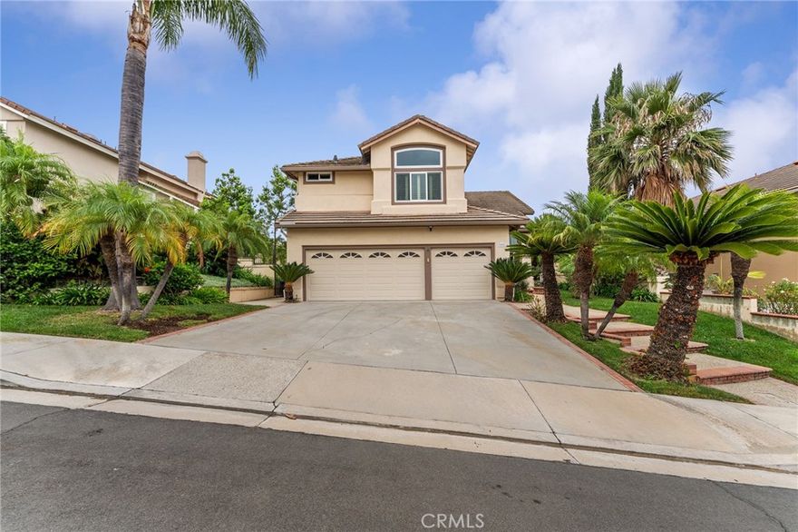 Perched atop a serene cul-de-sac in the prestigious Portola Hills enclave of Trabuco Canyon, this beautifully maintained two-story home offers an unparalleled lifestyle. Enjoy panoramic vistas—from the shimmering Pacific Ocean to untouched wilderness—right from your doorstep in one of Southern California’s most exclusive neighborhoods.

A grand hardwood staircase sweeps upward upon entry, setting a warm, sophisticated tone. The open-concept main level is designed for both relaxation and entertaining, featuring vaulted ceilings, rich wood finishes, and custom cabinetry.

The formal living and family rooms are bathed in natural light, enhanced by elegant shutters and windows that frame scenic views. Whether enjoying a quiet evening or hosting guests, these spaces balance comfort and style.

Culinary enthusiasts will love the expansive chef’s kitchen, outfitted with hardwood cabinetry, granite countertops, and a central island. Premium appliances include a Viking cooktop, double oven, microwave, dishwasher, refrigerator, and 48-bottle wine cooler—everything needed to elevate meals or entertain with flair.

The adjacent dining area features soaring ceilings and abundant sunlight, making every meal feel special.

Just off the main living area is a versatile fourth bedroom, currently used as a wired office—ideal for remote work or study. A nearby full bathroom makes this wing perfect for guests or multigenerational living.

The laundry room, with washer, dryer, utility sink, and storage, connects directly to the oversized three-car garage with built-in cabinetry.

Upstairs, retreat to a luxurious primary suite that feels like a private resort, with vaulted ceilings, sitting area, expansive closet, and spa-inspired ensuite featuring a soaking tub, dual vanities, and sunlit shuttered windows.

Two additional bedrooms share a thoughtfully designed full bathroom. A bonus room between them is perfect as a playroom, media space, or reading nook.

Retreat into the beautifully landscaped backyard and enjoy Southern California living year-round. The private patio is ideal for al fresco dining, entertaining, or relaxing while kids play on the lawn.

Residents enjoy access to Portola Hills HOA amenities, including a pool and spa, kid's pool, clubhouse, tennis courts, playground, nearby hiking and biking trails.

Families will appreciate being near award-winning Portola Hills Elementary School, known for academic excellence and community spirit.