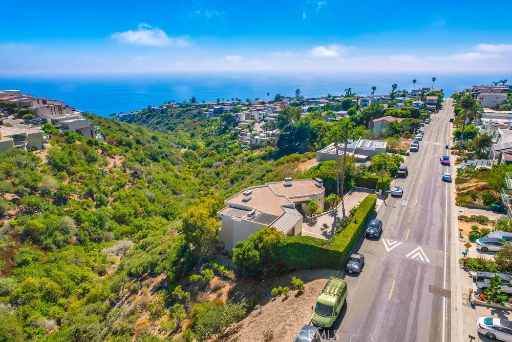Experience the pinnacle of coastal living in this fully furnished Laguna Beach masterpiece. Perched on an oversized lot with sweeping, unobstructed ocean, Catalina, and sunset views, this 3-bedroom, 3-bath, 3,895 sq. ft. residence has been meticulously remodeled with designer finishes and custom european furniture and bedding and thoughtful details throughout.
The open-concept floor plan showcases expansive walls of glass that blur the line between indoors and out, flooding the home with natural light and framing breathtaking panoramas from nearly every room. The chef’s kitchen boasts top-of-the-line appliances, custom cabinetry, and an oversized island, perfect for entertaining.
The spacious primary suite is a true retreat, featuring a spa-like bath, walk-in closet, and private balcony to savor the endless views. Two additional bedrooms provide comfort for family or guests, while multiple living areas offer flexibility for work, relaxation, or gatherings. There is also a Media room with 106" projection screen and black-out drapes and an oversized inviting sectional perfect for a movie night
Outdoors, enjoy an expansive patio and terraces ideal for al fresco dining, lounging, and watching the sun dip below the horizon.
3 Car Garage with Ample Storage space and an EV charger. Extra Long Driveway.
Situated just minutes from Laguna’s world-class beaches, art galleries, and dining, this rare furnished lease offers an unparalleled lifestyle—refined, serene, and effortlessly. Located in the majestic back canyons, this rental offers easy access to hiking, mountain biking, and tennis, as well as walking trails, to explore the beauty of Laguna beach. Truly a pride of ownership, and a perfect luxury getaway retreat and a MUST SEE.