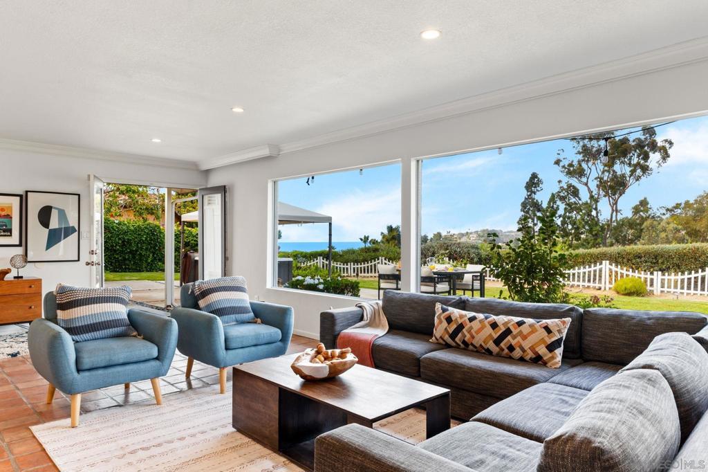 Panoramic ocean views and single-level living await in this 4-bedroom La Jolla retreat. Perched on a half-acre lot in Hidden Valley / Via Capri, this home offers sweeping vistas of La Jolla Shores and the Pacific from the living room, primary suite, and expansive backyard. The bright, open layout features a fully equipped kitchen, spacious game/media room with 55" TV and foosball, and four well-sized bedrooms. Outdoor living shines with a firepit, hot tub, and plenty of space for entertaining or relaxing while enjoying sunsets over the ocean. Additional highlights include generous parking for multiple vehicles and a pet-friendly design. Ideal for those seeking a blend of coastal serenity and convenience, with easy access to beaches, village shops, dining, and nearby trails like Torrey Pines.