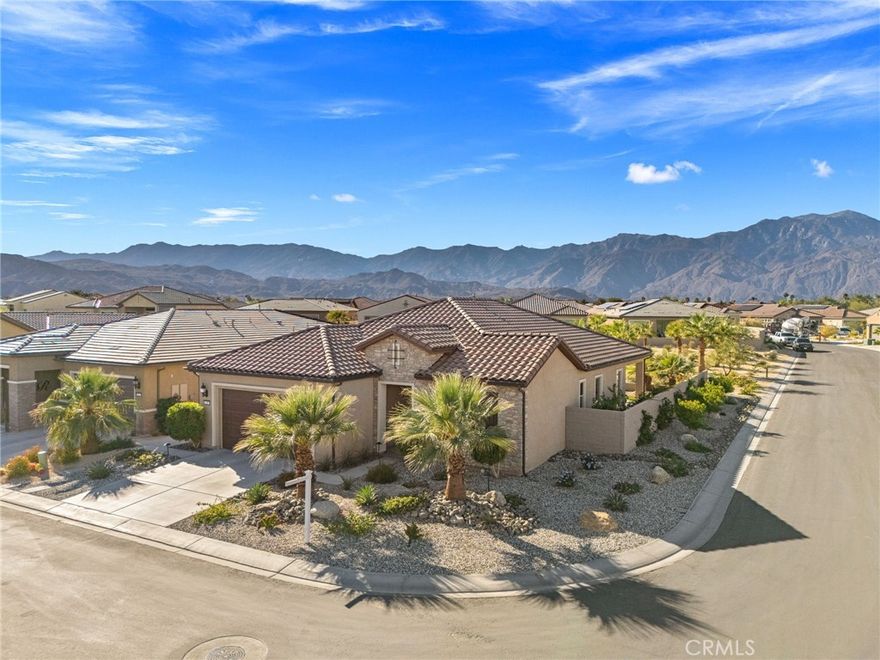 Welcome to this highly sought-after Sanctuary Model, the most popular floor plan in Del Webb Rancho Mirage, ideally positioned on a premium corner lot with exceptional privacy and curb appeal with owned solar. Designed for effortless desert living, this home offers a perfect blend of luxury, comfort, and indoor-outdoor flow. The beautifully landscaped backyard showcases spectacular mountain views with direct sightlines to the community walking path—an ideal setting for morning coffee, sunset entertaining, or peaceful evening relaxation. Expansive multi-slide patio glass doors flood the interior with natural light and create a seamless transition between indoor and outdoor living spaces. Inside, the home features an extensively upgraded interior, including black honed granite countertops, porcelain tile flooring, upgraded cabinetry, motorized window shades, designer lighting and faucets, and premium appliances, delivering both elegance and functionality. The thoughtfully designed layout offers two and one-half bathrooms, with each bedroom featuring a private en suite bath, plus an additional half bath for everyday convenience and entertaining. Located in the guard-gated Del Webb Rancho Mirage, residents enjoy resort-style amenities including a state-of-the-art clubhouse, fitness center, pools and spas, pickleball and tennis courts, walking trails, and a vibrant social calendar—all within a secure, 55+ active adult community. With easy access to golf, dining, shopping, and all that Rancho Mirage has to offer, this home delivers the ultimate desert lifestyle. This is a rare opportunity to own one of Del Webb’s most desirable models in a premier location—a must-see home that truly has it all.