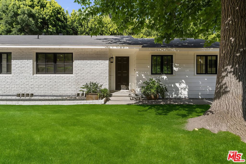 Tucked away in the prestigious Brentwood Loop just north of Sunset Blvd, this thoughtfully updated 3-bedroom, 2.5-bathroom single-story home blends timeless style with modern upgrades and future potential. Just minutes from the highly rated Kenter Elementary School, the home offers privacy, convenience, and indoor-outdoor California living at its best. A bright, open floor plan welcomes you with brand-new white oak flooring, smooth walls and ceilings, and sliding French doors that open to a beautifully landscaped patio and expansive backyard. The kitchen features a center island and breakfast area, perfect for casual dining and entertaining. Major upgrades include: upgraded electrical with new main panel, LED lighting (interior/exterior on timers), and EV charger, upgraded plumbing throughout, and upgraded HVAC system with linear diffusers. The laundry has been relocated to garage to allow for new powder room. New interior doors, entry door, garage door, and most windows. Custom walnut walk-in closet with built-in shelving the primary suite. Foundation retrofitting to code. Enjoy a heated outdoor seating area with jacuzzi, tranquil water feature, new side gates, and a modern drip irrigation system. Whether move-in ready or a redevelopment opportunity (up to 3,673 SF above grade), this rare offering sits in one of West LA's most sought-after neighborhoods.