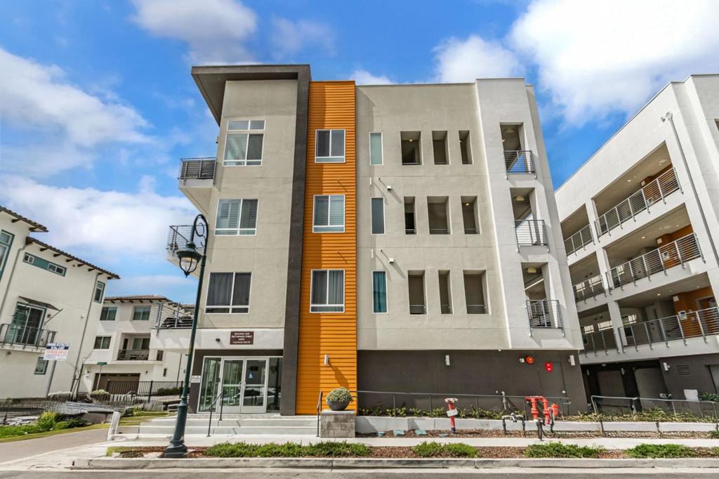 Welcome to this charming open and versatile floor plan; 1-bedroom condo with a den that can be used as a 2nd bedroom/den/home office. This executive condo is designed with upgraded top-of-the-line amenities. 3027 Manuel Street #6 is located in the vibrant much-sought out Communication Hills. This cozy 822 sq ft residence offers a well-equipped kitchen featuring a gas cooktop/built-in gas oven, dishwasher, microwave, smart refrigerator making meal preparation a breeze. The home boasts of beautiful laminate flooring throughout creating a modern and easy-to-maintain living space. Natural lighting from the oversized windows/patio door leads out to the balcony allows for an enjoyable morning coffee or evening sunsets. The inviting rooftop sky deck is furnished to provide relaxation and family/friends entertainment with scenic views perfect for warm gatherings and cozy evenings.. Laundry is conveniently located inside, with a full size washer and dryer included. This home was built in 2022, and lived in by its original owner. Additional features include a tandem 2-car garage & tankless hot water heater. This home is an excellent find in the heart of San Jose with essential amenities to suit your exquisite lifestyle in Communication Hill Community.