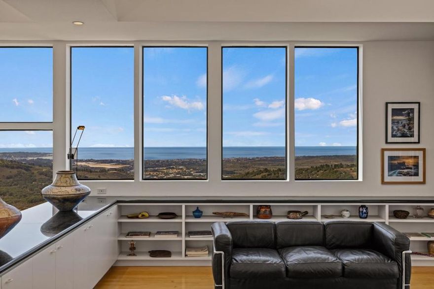 Contemporary elegance with breathtaking Monterey Bay views. Perched atop the serene and lush setting of Saddle Road, this contemporary modern masterpiece embodies a refined architectural vision defined by elegant proportions, clean lines, and meticulous attention to detail. Soaring ceilings and strategically placed light tunnels flood the home in natural light, creating a luminous and uplifting ambiance. The open-concept floor plan flows with grace, intentionally designed to guide your gaze toward the sweeping panoramic views of rolling oak-studded hills and the Monterey Bay beyond. Sleek, floor-to-ceiling cabinetry blends form and function, offering minimalist beauty and exceptional utility in every space. This home is a harmonious blend of contemporary design, artistry, and natural serenity just minutes away from all the wonderful amenities of the Monterey Peninsula.