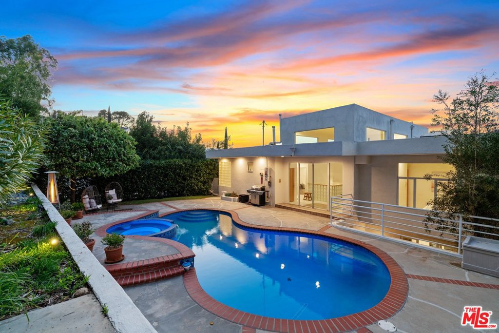 NEW VIRTUAL TOUR https://my.matterport.com/show/?m=S7f9ZuRkRxK Don't miss the opportunity to own this stunning 4 bed 4 bath 3900+ sq ft home in a highly desired South of the blvd neighborhood of Sherman Oaks! Boasting soaring ceilings and incredible views from almost every room, this architectural dream home is a must see! The home features an impressive chefs kitchen with new appliances, custom finished 3 car garage (totaling 691 sq ft not included in living area with multiple storage rooms), elevator and an entertainers yard with a newly resurfaced pool (including pump, filter and heater). Take in beautiful sunsets from the master suite with sitting area, private veranda, large walk in closet and grand master bath with spa tub. Perched atop the home is the masterpiece office/den with 180 degree views from its floor to ceiling windows perfect to spur creativity. Recent upgrades include a fully paid solar panel system, custom fireplace and built ins in living room, home automation!