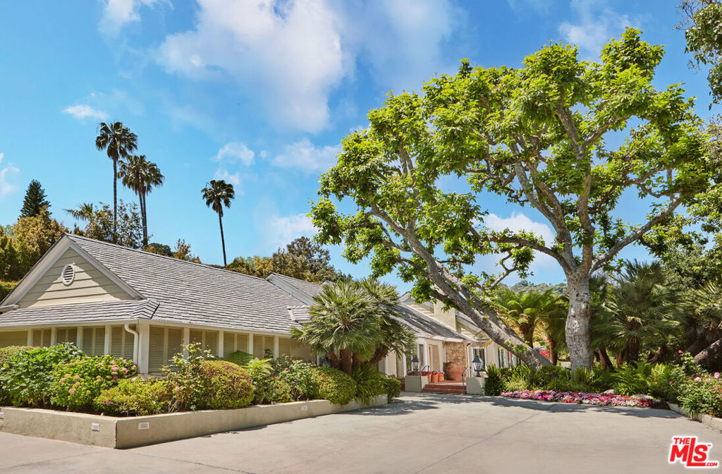 Hugging the 15th fairway of the prestigious Bel-Air Country Club, this sprawling one-story jewel was originally conceived by renowned designer-builder Carlton Burgess in 1942. It was soon purchased by director Alfred Hitchcock and became known for decades as Hitchcock's secluded sanctuary. In 1983 it underwent an extensive renovation. Fountained entry leads to an expansive living room with vaulted ceiling, a massive fireplace, and intricate ceiling details in both the living room and the extensive hallway. Beautifully proportioned formal dining room and large center island chef's kitchen detailed in hand-painted tiles and brilliant blue Brazilian granite. Additionally, there are two rooms that can be converted into additional bedrooms for staff, a cooled wine storage area, and a hidden upstairs office/guest room with plumbing in place, easily expandable to accommodate an additional guest bedroom.The property offers two significant bedroom suites. One is designated for guests and features a full white marble bath. The primary suite boasts luxurious dressing areas and oversized, generous baths. Elegant outdoor garden areas include a a dining pavilion, creating a romantic mood reminiscent of the Hotel Bel-Air. Double motor court, gated entry, covered parking for three cars, and separate storage buildings. A rare and remarkable offering.