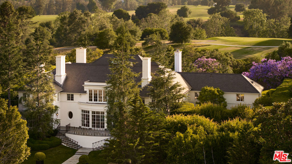 The Rutherford House is a masterpiece of architectural design, showcasing unparalleled quality and attention to detail. Located on the most desirable street in Beverly Hills, the one-of-a-kind residence blends old Hollywood with modern luxury. Upon entering the grand entrance, guests are greeted by a classic, winding staircase and a magnificent view that reveals the impressive back grounds. The main level features a formal living and dining room, Ruhlmann-inspired library and billiard room, bar, and grand morning room lined with 18th-century wallpaper and original fireplace. The kitchen is functional yet breathtaking with decadent marble, mosaic-tiled ceiling, and top-of-the-line appliances. A primary suite features marble bathrooms, oversized closets, and a separate lounge area that overlooks a manicured garden. Outside is a pavilion with an oval pool and pool house inspired by Paul Williams' remarkable design. With many more features throughout, this iconic estate must be experienced to be believed. Step into timeless elegance and rich history with the Rutherford House.