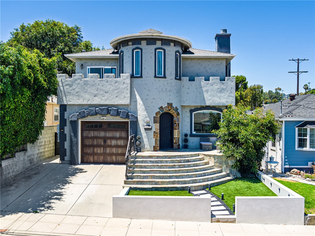 Welcome to your dream home, perched on a quiet cul-de-sac with breathtaking views of the LA Harbor, Downtown Los Angeles, and the San Gabriel Mountains. This stately 5-bedroom, 3-bathroom residence has been thoughtfully updated and is perfectly designed for both entertaining and comfortable everyday living.
The home’s ornate façade makes a striking first impression, while the newly installed turf lawn offers a clean, low-maintenance exterior. Step inside to a beautifully refreshed interior featuring new flooring and fresh paint throughout. At the heart of the home is an expansive chef’s kitchen with a massive island and built-in cooktop, seamlessly connected to the living room—perfect for gatherings of any size.
Enjoy a variety of spacious living areas, including a formal dining room that comfortably seats ten, a separate formal living room, and a cozy family room. Upstairs, the primary suite serves as a luxurious retreat with a newly renovated, spa-inspired bathroom boasting a soaking tub, separate shower, and walk-in closet. One of the additional upstairs bedrooms has been transformed into a custom-designed dream dressing room, which can easily be converted back. Two more bedrooms are located upstairs, with a fifth bedroom downstairs adjacent to a full bathroom—ideal for guests or a home office.
The backyard is a private, resort-style oasis featuring a heated pool and jacuzzi, outdoor lounge with a covered TV area, built-in BBQ island with refrigerator, and solar panels to help offset energy costs.
This home offers privacy, personality, and modern comfort in a location surrounded by parks, hiking trails, natural beauty and easy access to freeways and dining. Far from cookie-cutter, this is your chance to own a truly one-of-a-kind residence with character and charm.