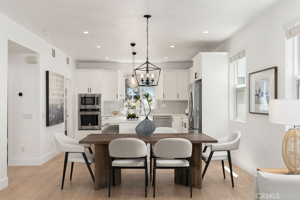 An exceptional opportunity to own a fully detached, newly remodeled home in The Place, a premier enclave within the vibrant 17 West community. Ideally located just off of 17th Street and Newport Blvd, this tri-level residence offers both privacy and convenience in a desirable location. Step inside to find brand-new flooring throughout, quartz countertops, designer Bedrosian tile, and curated finishes and fixtures that elevate every room. Each of the two primary suites is complemented by generous walk-in closets and spacious bathrooms with dedicated water closets, ensuring a comfortable and refined living experience. The third bedroom, on the first level, offers its own walk-in closet and en-suite bath with soaking tub. The open-concept kitchen and living area provide an ideal space for entertaining. The kitchen includes a large center island, walk-in pantry, and ample counter space. Thoughtfully designed for modern living, the home includes generous storage throughout, featuring dedicated linen and laundry closets. The expansive rooftop deck is a showstopper - one of the best in the community. Covered in premium artificial turf, this space boasts a covered lounge with TV, as well as an outdoor kitchen complete with barbecue, sink, refrigerator, and ice chest. Additional upgrades include Nest thermostats and electric vehicle charging in the garage. Residents of 17 West enjoy community amenities such as barbecues, green spaces, shuffleboard, and a children’s play structure. Minutes from the best shopping and dining that Newport Beach and Costa Mesa have to offer, 608 Malibu offers an authentic coastal lifestyle while providing easy access to PCH, major freeways, and John Wayne Airport.