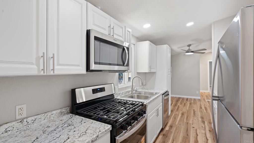 Newly Remodeled 3 Bed, 2 Bath Home with Oversized Porch! Welcome to 13490 Highway 8 Business #8 in Lakeside. This bright, open home features vaulted ceilings, recessed lighting, and brand-new vinyl flooring throughout. The kitchen offers updated appliances, stylish cabinetry, and plenty of counter space. Both bathrooms have been upgraded for a modern touch. The split floor plan provides privacy, with the primary suite featuring its own en-suite bath. Additional highlights include a large laundry room, central A/C and heat, dual-pane windows, and a newer roof. Step outside to enjoy the oversized porch with mountain views, a freshly mulched yard, and a storage shed. This home is located at the end of a quiet cul-de-sac in a welcoming, family- and pet-friendly community with a pool and clubhouse, and it’s conveniently close to shopping, dining, schools, and freeway access.