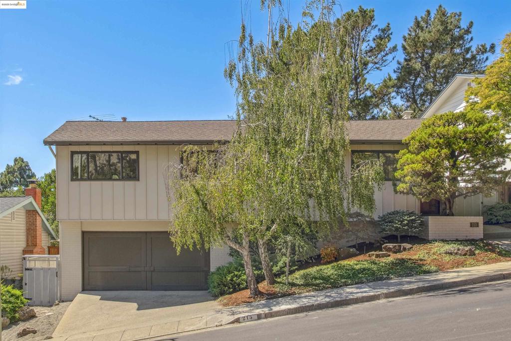 This quality, mid-century home with Bay views and an elegantly designed garden is located in the highly desirable Crestmont neighborhood. It is conveniently located to Highway 13 and Highway 580. The local community offers shopping at the top-rated Skyline Community Market and nearby Montclair. Abundant outdoor activities are available at the Oakland Hills Swim & Tennis Club, Joaquin Miller Dog Park, Redwood Regional Park, Robert’s Park, and Redwood Equestrian Arena. The main living and dining area features a stone fireplace and an expansive window wall which opens onto a deck with Bay views and overlooks a serene garden. Hardwood floors span most of the upper level. The kitchen has been recently updated with all new appliances and offers a spacious eating area plus plenty of storage. The spacious primary bedroom has two closets, bay views and an updated bathroom with a tub. There are also two other bedrooms and a second updated bathroom on this level. The lower level has a spacious family room with built-in shelving, a wet bar, an office, large storage areas, and access to the garden. There is a half bathroom, two workshop areas, and laundry facilities adjacent to the 2-car garage. The back garden has a level lawn, meandering pathways and an Asian inspired landscape area.
