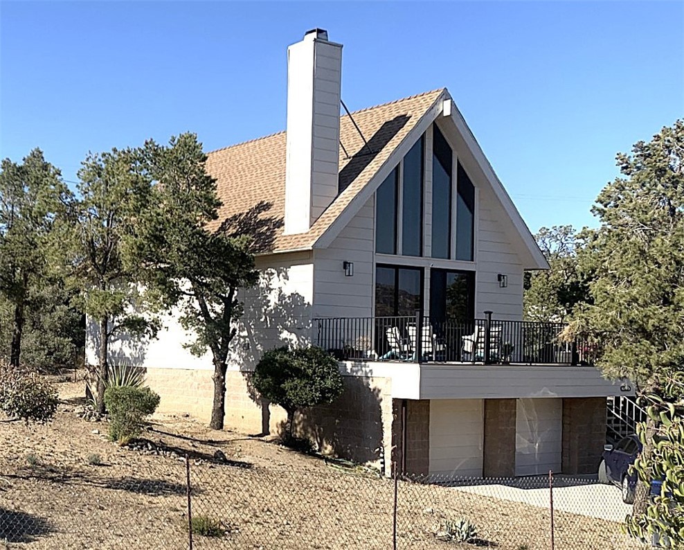 Turnkey Mountain Cabin with Spectacular Views and Modern Upgrades ~ This beautifully maintained A-frame cabin offers the perfect blend of mountain charm and modern convenience ~ Located just 20 minutes from El Paseo, 25 minutes to Idyllwild, and under 2 hours to several international airports, it's the ideal full time residence or weekend escape ~ Enjoy panoramic views of the Santa Rosa Mountains from the new trex deck~ The home features easy access from the highway and a finished two-car garage with direct entry ~ Inside, the open-concept great room showcases vaulted ceilings, expansive windows, a cozy wood-burning fireplace, and a well-equipped kitchen and dining area ~ The main level includes two bedrooms with walk-in closets, a full bath, and a laundry area with washer and dryer ~ Upstairs, a large loft space with stunning views offers flexible use as a primary bedroom, guest suite, or home office ~ Recent upgrades include a new HVAC system, new appliances, fiber optic internet, and strong cell service ~ A private well supplies excellent water, and the fenced and gated yard makes it pet-and child friendly ~
This move-in-ready home is the perfect blend of comfort, convenience, and natural beauty~