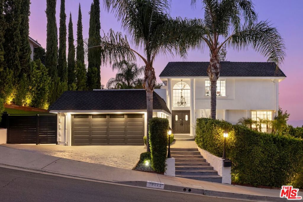 Discover this recently remodeled Tarzana retreat, where timeless elegance meets modern design. Perched in the hills with sweeping city-light and mountain views, this residence offers an elevated lifestyle with seamless indoor-outdoor living.An open floor plan creates a natural flow for entertaining, with expansive living spaces that connect effortlessly to the outdoors. The chef's kitchen is a true centerpiece, featuring stainless steel appliances, custom cabinetry, and a generous island designed for both culinary creations and gatherings.The primary suite provides a tranquil escape, while additional bedrooms and flexible living areas accommodate family, guests, or a private office.Step outside to your own private oasis a secluded backyard designed for both relaxation and entertaining. Enjoy the sparkling pool with its soothing waterfall, expansive patio deck overlooking the city lights, and multiple lounge areas ideal for hosting unforgettable evenings under the stars. Manicured landscaping and serene privacy complete this exceptional outdoor retreat.