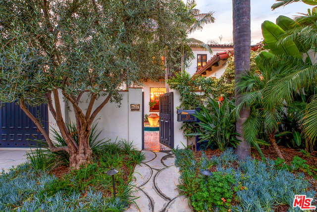Gated authentic chic Spanish masterpiece has been painstakingly updated while retaining its original architectural integrity. Splashing fountains, private courtyard & tranquil backyard create opportunities to entertain or simply retreat.The decadent large formal living room dazzles with intricate wood beamed ceilings, grand fireplace & a floor to ceiling picture window. An elegant pub/bar room accents the design of this remarkable home. Chef's kitchen features a large center island and casual breakfast room. The formal dining room showcases hand painted & coffered ceiling complete with butler's pantry & 150 bottle wine storage. Upstairs highlights 3 bdrm suites, plus an additional bedroom/ office space. The spacious master with luxurious bath & 2 walk-in closets overlooks the private courtyard and lush trees lining Sierra Dr in the highly coveted Beverly Hills Flats. Completely private resort like grounds feature pool, spa, cabana/gym, detached 1-bdrm GH & 2car garage w alley access.