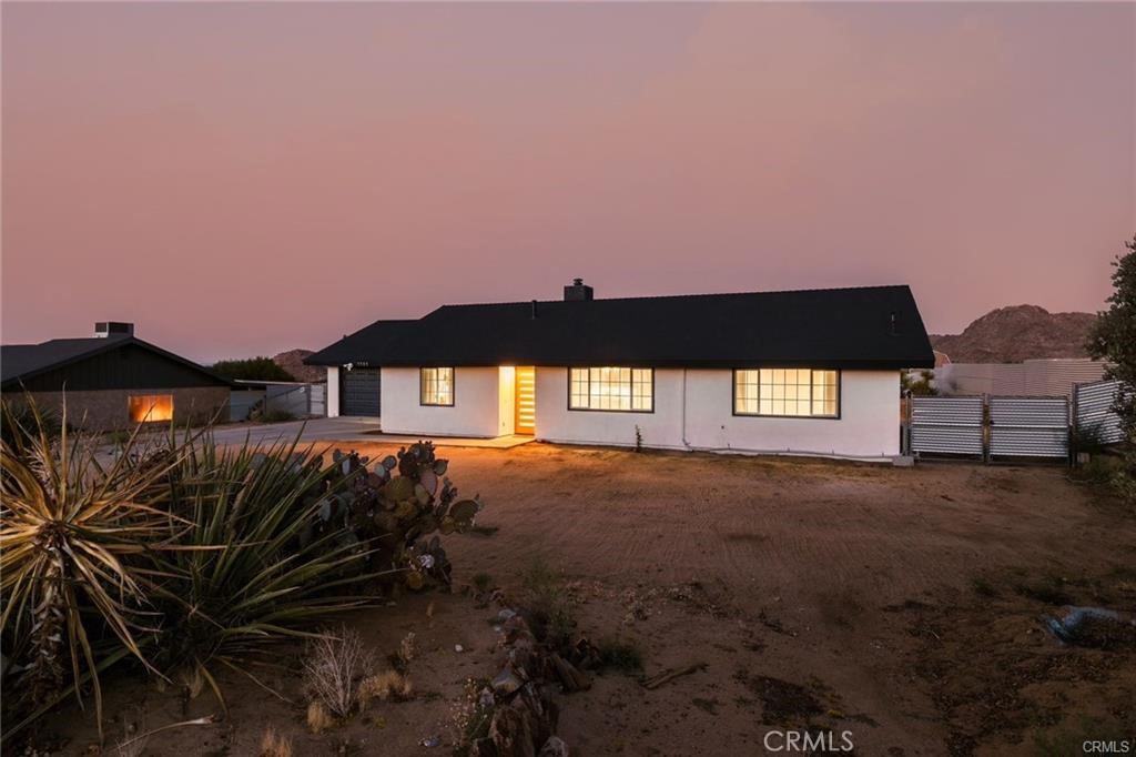 Welcome to 7795 Sunset a beautifully updated 4 bedroom, 2 bathroom home in one of Joshua Tree’s most desirable neighborhoods, just minutes from the National Park. This 1,796 square foot home offers an open concept layout with a modern kitchen featuring quartz countertops and a breakfast bar. Each bedroom is equipped with its own mini-split A/C unit for personalized comfort. The garage has been converted into a versatile game room, and the fully fenced backyard is designed for entertaining, complete with an above ground pool, hot tub, fire pit, and views of the mountains and desert landscape. A spacious laundry room and ample parking add to the homes convenience.