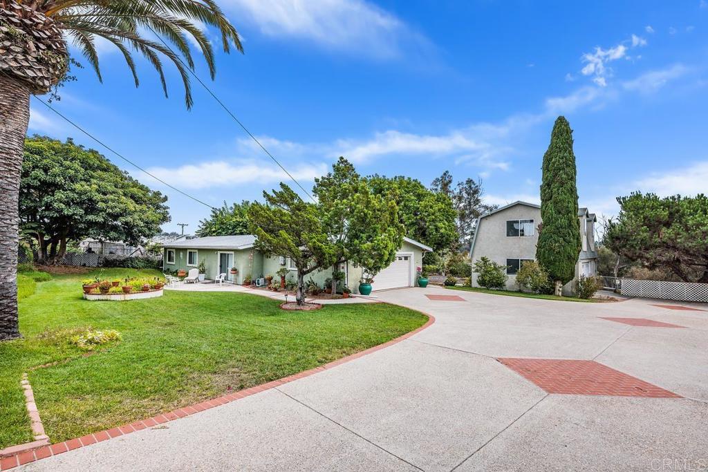 Unique opportunity in Vista!! Large 1/2 acre lot with 3 bedroom single level home with 2 car garage and a studio ADU above detached 2 car garage or workshop! Access by long driveway easement to the secluded lot with privacy. Cute kitchen with painted cabinets and lots of storage...dining room is off the kitchen. Spacious Living room offers a fireplace! Both bathrooms, the hall bath and the primary bath were updated a few years ago. Halls are wide to allow for handicap access. This home, lot, and Studio ADU offers tremendous potential for multigenerational living, home business, workshop, studio. Home is being sold by the trust and is currently being cleaned out for the trust. To be sold "AS IS"