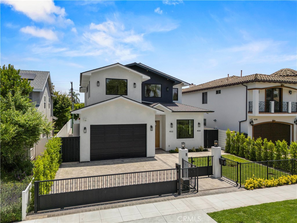 Welcome to 4532 Katherine Avenue — a brand-new, ground-up construction in the heart of the coveted Library Square neighborhood of Sherman Oaks. This gated modern residence offers 3,161 sq ft of expertly crafted living space with 5 bedrooms and 5.5 bathrooms in the main home, plus a fully finished 515 sq ft ADU complete with its own bedroom and full bath — ideal for guests or extended family. Designed with spaciousness and flow in mind, the home features soaring 11-foot ceilings on the first floor and 9.5-foot ceilings upstairs, creating a bright and open atmosphere. The living room is anchored by a sleek fireplace and floor-to-ceiling sliding doors that open to the backyard, delivering the ultimate indoor/outdoor California living experience. The gourmet kitchen is a true centerpiece, featuring high-end Bertazzoni appliances, custom cabinetry, designer finishes, and a built-in beverage cooler. Upstairs, the primary suite offers a tranquil retreat with a fireplace, built-in sink and beverage cooler, a spa-like en-suite bath, and a walk-in closet with custom shelving. This smart home is equipped with fully integrated technology to control lighting, fireplaces, HVAC, pool speakers, and a Sonos sound system, and it comes complete with a security camera system for peace of mind. Additional highlights include Hansgrohe faucets throughout, an attached garage, three separate HVAC systems (for each floor and the ADU), and a dedicated laundry room with Samsung washer and dryer included. Set on a quiet, tree-lined street in Library Square, this gated, camera-secured property blends modern luxury, high-tech convenience, and timeless comfort in one of Sherman Oaks’ most desirable neighborhoods.