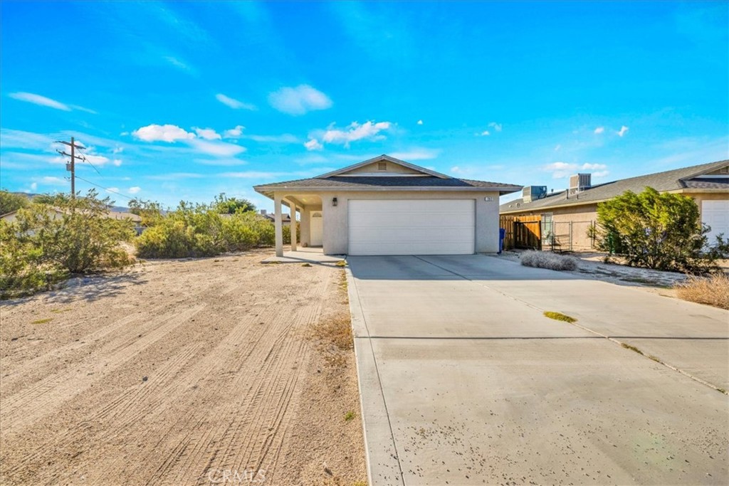 Welcome to 6262 Smoke Tree Avenue, a beautifully maintained 2-bedroom, 2-bathroom home offering comfort, style, and convenience in the heart of Twentynine Palms. Step inside to discover a warm and inviting living space with carpeted floors and abundant natural light. The kitchen features modern Samsung and LG appliances all under 3 years old plus elegant tile flooring and plenty of counter space for easy meal prep. Both bathrooms are designed for relaxation and functionality, each featuring a shower/tub combo. The primary suite includes an attached bathroom and generous closet space, creating a perfect retreat after a day of exploring the desert beauty nearby. This home offers central heating and cooling for year-round comfort, as well as a swamp cooler, an excellent energy-efficient option to help reduce utility costs during the warmer months. Outside, enjoy stunning mountain views from your backyard that has wood fencing for privacy, ideal for entertaining, stargazing, or simply unwinding in the peaceful desert air . From the kitchen, you’ll enjoy direct access to the attached 2-car garage a convenient feature for bringing in groceries or stepping out to the laundry hookups, located neatly inside the garage, which also provides extra storage and convenience. Located close to downtown Twentynine Palms and the entrance to Joshua Tree National Park, this property offers the best of both worlds quiet residential living with easy access to local shops, dining, and outdoor adventure. Whether you’re seeking a full-time residence, a desert getaway, or an investment opportunity, this home delivers the perfect blend of comfort, location, and value.