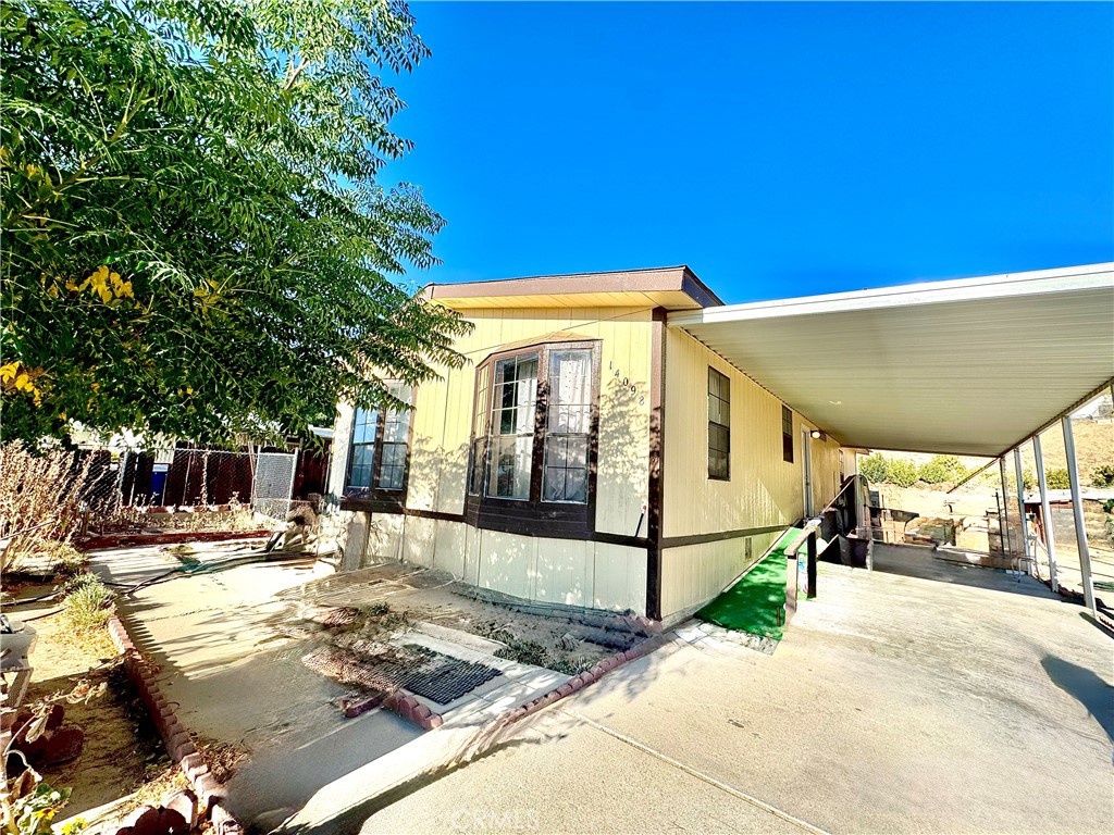 This 3 bedroom, 2 bathroom manufactured home on its own land—no space rent! Built in 1989, the home features a functional single-story floor plan with a spacious living area, open kitchen, and ample natural light. Enjoy central heating, evaporative cooling and central air conditioner , and a convenient carport for off-street parking. Sitting on a 0.26-acre lot, there’s plenty of room for outdoor living, gardening. laundry room area inside the home .Conveniently located near shopping, schools, and commuter routes, this home offers both comfort and value—schedule your showing today!