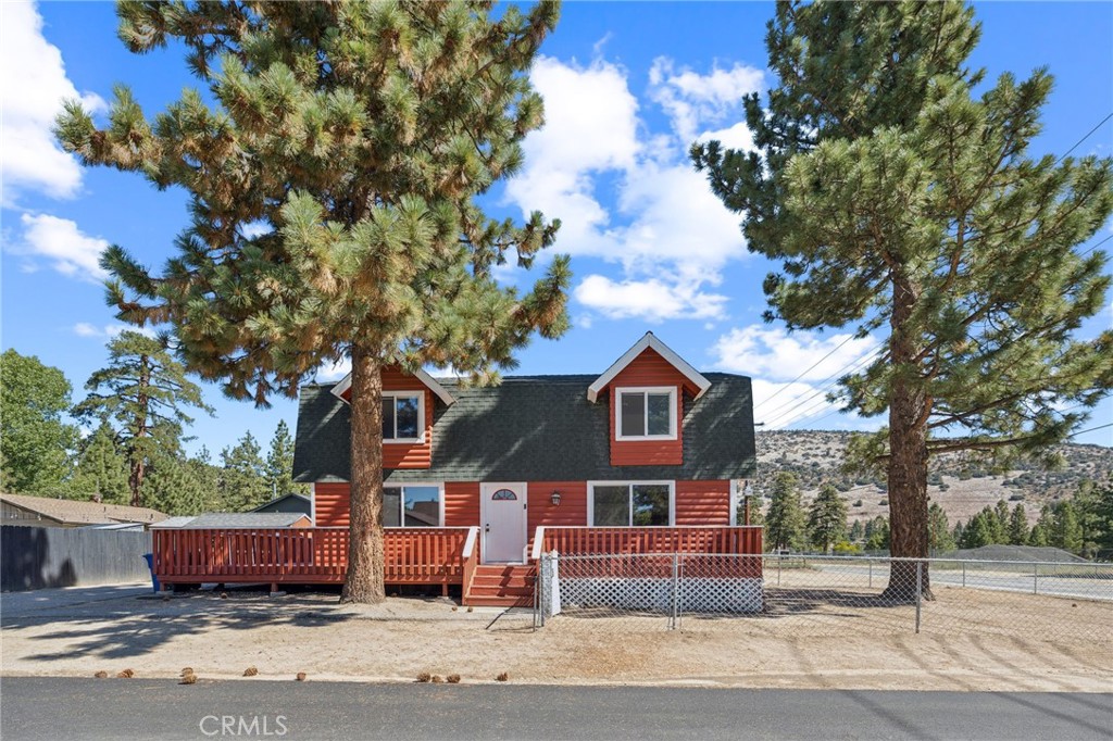 Step into the mountain charm with this classic Gambrel-style home, perfectly situated on a spacious corner lot in the heart of Big Bear. With its signature A frame roofline and inviting open floor plan design, this home offers the perfect blend of cozy cabin vibes and modern comfort. Enjoy stunning alpine sorroundings, with the majestic mountains practically in your backyard and easy access to Big Bear Village, the village shops, and year round adventure. The property's corner location provides added privacy and curb appeal, while offering plenty of space for parking, outdoor entertaining on the amazing deck. At the heart of your home is a stone fireplace adding a touch of mountain charm and creates a warm inviting atmosphere perfect for hosting family and friends after a day on the slopes. The seamless flow between the kitchen and living area make this home perfect for entertaining or relaxing
