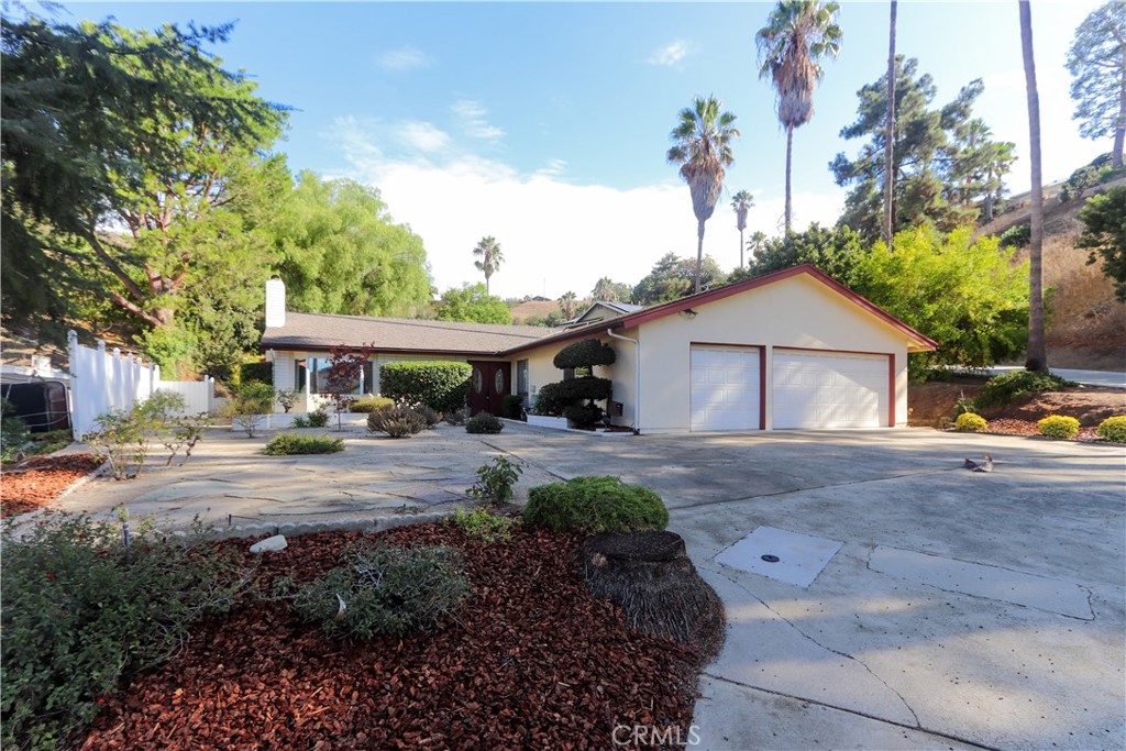 Welcome home to 21833 Onawa Pl in Diamond Bar! Peaceful and quiet, this cul de sac location amongst mature trees sits in the coveted Walnut Valley Unified School District and cannot be beat!! Single story stunner with 4 bedrooms, 2 baths and a primary suite with an en suite bathroom. Step through the double door entry into the light and bright front living room featuring bamboo floors, recessed lighting, window seat and cozy fireplace. Perfect spot for entertaining and enjoying family gatherings during the upcoming holiday season! Family room with dining combo await just off living room and kitchen, featuring newer sliding door and gorgeous views of the private backyard. Kitchen has plenty of storage, newer oven and beautiful views of the backyard. Individual laundry room with side yard access is just off of kitchen. Primary suite features an entry hall with double closets, an en suite bathroom, hardwood floors and plantation shutters. 3 additional bedrooms offer plenty of space for your growing or multigenerational family! Large driveway features plenty of parking and 3 car attached garage. Front yard offers low maintenance plantings and generous side yard has potential for trailer parking. Private backyard is your new retreat and features a quiet seating area, horseshoe area, tetherball area, lawn and bark areas and beds for planting. The possibilities are endless with this much space. There is room for a pool, room for a California outdoor room with entertainment area and kitchen, more garden beds and specialized plantings, or enclosures for pets! Over one half acre total. Several big ticket items are done, including newer hvac and a/c, newer windows, newer sliding door, oven and tankless water heater. Educational opportunities abound in Diamond Bar, with award winning Evergreen Elementary and Diamond Bar High Schools less than 1 mile away, and Chaparral Middle School less than 2 miles. The prestigious Claremont Colleges are a short 20 min drive and Mt San Antonio College is a short 14 min drive. Located 1 mile from the 57 freeway, and close to world class education, shopping parks, medical offices, restaurants, and specialty stores, this location is second to none!