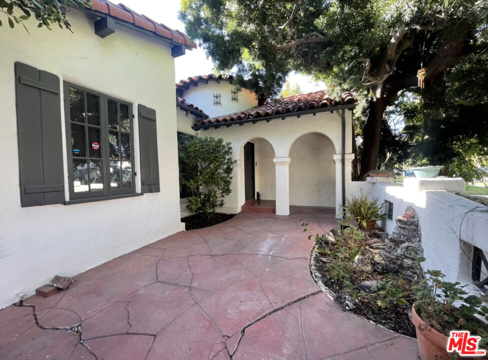 Full of original character, this 3-bedroom, 2-bathroom Spanish-style home is located just minutes from The Grove and Pan Pacific Park. Features include high ceilings, arched windows, hardwood floors, and a decorative fireplace. Spacious living and dining areas maintain their classic appeal. The kitchen and baths are vintage and ready for your personal touch. The primary bedroom offers backyard access, and the private yard is ideal for relaxing or entertaining.