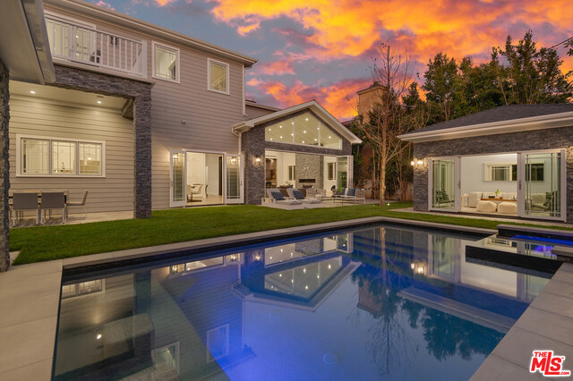This stunning brand new home on an extra wide lot in Brentwood Flats was built with meticulous attention to detail and spacious open floor plan epitomizing indoor/outdoor living. The home opens up to the expansive formal living & dining room w/ 12ft ceilings, stone fireplace & leads out to the private courtyard w/ a dramatic 18 ft fireplace. Continue through the home to the family room & full bar w/ wine storage room, vaulted 20 ft ceilings & bi fold door allowing the room to completely open up to the backyard. The expansive chef's kitchen features custom cabinetry, top of the line appliances, beautiful stone counters & additional dining area. The backyard has everything you would want for entertaining including pool, pool house, outdoor covered kitchen that is dropped down so you can serve food and drinks directly into the pool, dining & sitting area. The oversized master bedroom features vaulted ceiling, decks off both sides, fireplace, his/her closets & sun filled master bath.