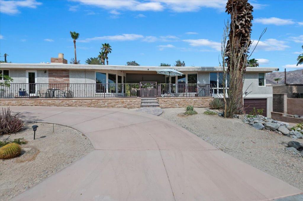 Discover a unique blend of character and comfort in this beautifully designed desert home in La Quinta. Situated on an elevated lot with sweeping views of the Santa Rosa Mountains, this rental offers privacy, space, and standout style. The main home boasts an open concept layout with dramatic windows that bring the outdoors in. Custom finishes include exposed wood beams, stained concrete floors, and a striking fireplace that anchors the living space. The newly updated kitchen features a modern galley layout and direct access to a private front patio, perfect for al fresco dining or quiet mornings. Tucked away is a detached guest casita with its own living area, echoing the main home's mid-century design elements and natural light. Below the casita, you'll find a spacious two-car garage, storage area, and dedicated laundry setup. Outdoors, the front entry welcomes with desert-friendly landscaping and a circular drive for easy access. The backyard is designed for leisure, complete with mature greenery and a vintage inspired pool that stays true to the home's original charm. Enjoy efficient climate control with a three-zone split AC system and take advantage of walkable access to nearby trails and outdoor recreation. This is more than just a rental, it's a design-forward retreat ready for those who appreciate architecture, comfort, and views.