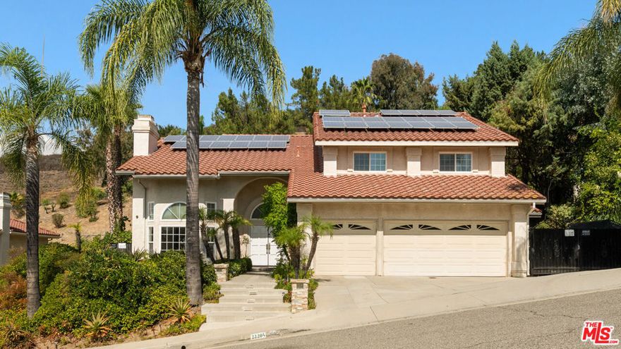 Framed by sweeping hillside views in Mulholland Heights, this approximately 3,900 sq ft residence delivers refined living in a private and secure setting. With 24 hour security, a neighborhood park and nearby trails, it is a polished retreat with every amenity imaginable. Inside, clean architectural lines and soaring ceilings create a calm, open atmosphere. Natural light fills the living and dining rooms, highlighting refined finishes and a thoughtful layout. The kitchen pairs premium appliances with tasteful modern finishes and flows into a spacious great room designed for gathering or relaxing. On the lower level, two flexible bedrooms currently serve as a gym and playroom, ready to adapt as needed. The primary suite is a private retreat with generous proportions, a serene sitting area, dual walk-in closets and a spa-inspired bath finished with imported tile. Upstairs also offers well-appointed secondary bedrooms, each comfortably scaled for family or guests. Outside, a private setting invites recreation of any kind. A saltwater pool, professionally lit sports court and mature fruit trees including figs, peaches, apples, persimmons, loquats and grapes create a setting both vibrant and serene. A refined residence in Mulholland Heights offering privacy, strength and modern comfort, while just minutes from premier grocery stores, dining and everyday conveniences.