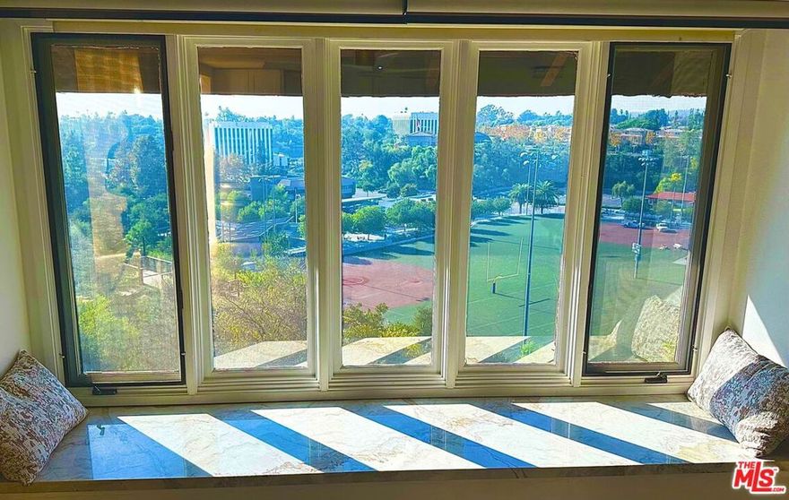 Welcome to 1307 Shadow Lane Unit I  a one-of-a-kind, penthouse-style condominium offering breathtaking panoramic views of Hillcrest Park, Lions Field, and the rolling hills of North Fullerton.This exclusive top-floor corner unit has no shared walls on either side, providing exceptional privacy and a true sense of serenity. Originally the model unit, it showcases an open-concept kitchen with a large island, new appliances, new flooring, and remodeled bathrooms filled with natural light.The spa-inspired primary bath features a Grohe Smart Shower System with two regular sprays, a rainfall showerhead, and a handheld wand  all with modern push-button technology for a luxurious experience.Enjoy seamless indoor-outdoor living with a private patio, built-in window seating, and access to a common rooftop terrace, ideal for entertaining or relaxing at sunset.Additional highlights include built-in Sonos surround sound speakers, a quartz fireplace surround, in-unit washer and dryer, and ample storage with three bedroom closets.The property offers two assigned parking spaces  a private garage and an additional carport  plus plenty of guest parking.Perfectly situated across from Hillcrest Park and within close distance to Fullerton College, restaurants, Starbucks, and Downtown Fullerton, this pristine residence blends luxury, convenience, and panoramic beauty in one unforgettable home.