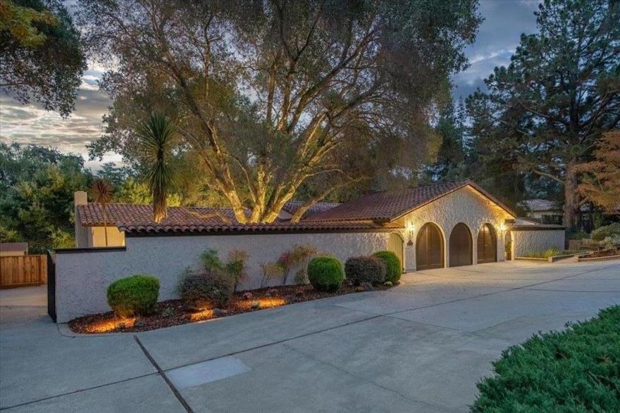 Gated and private, this elegant Spanish inspired home features tile roof, arch windows, stucco arches.  Serene, and private courtyard, with water fountain, extensive stone pavers, and a grand oak tree leads to a beveled glass double door entry to a spacious, bright and charming home. Spacious family room with vaulted ceiling, fireplace, and wet bar with French doors leading to a sunroom with stunning views. Large step down living room with arched windows. Spacious primary suite with attached sunroom/cozy sitting area to capture the stunning views, dual vanities, two walk in closets, and a sunken tub. Enjoy outdoors living, surrounded by mature trees, with stunning  views. The expansive multi level decks provide the ultimate setting for entertaining. Gleaming new refinished hardwood floors in most of the home. New plush carpet. Dual HVAC systems (2019). Water heater (2020). Remodeled laundry room with new cabinetry and stone top. New recess lighting throughout. Spacious 3 car garage, with new epoxy floor, and  carriage house design doors. Ample outdoor storage sheds. Fresh interior and exterior paint. Saratoga schools