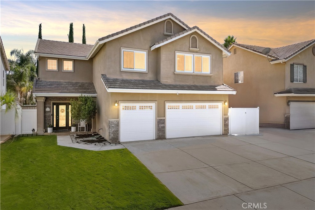 Welcome to this beautifully maintained 4-bedroom, 2.5-bath home offering 2,632 sqft of well-designed living space. Situated on a spacious interior lot within the Hidden Creek community in Wildomar, this home combines functionality, style, and efficiency. A charming covered porch and elegant glass-paneled entry lead into a tastefully designed interior brimming with natural light, soaring ceilings, and an open floor plan. The updated kitchen features modern appliances, designer touches, and a direct flow to the family room, making it perfect for both entertaining and everyday living. A custom stone fireplace and built-in cabinetry add warmth and character to the main level. Enjoy comfort year-round with energy-efficient solar panels, newer vinyl double-pane windows upstairs, a whole-house fan, and a tankless water heater. The exterior impresses with a widened driveway offering a 3-car garage with epoxy flooring, RV parking, and a covered patio that opens to a tastefully arranged backyard ideal for gatherings and outdoor dining. Thoughtful upgrades include a water drainage system for optimal yard care and low-maintenance living. Set on a generous 7,405 sqft lot with no HOA, this home offers the perfect balance of modern upgrades, energy-conscious features, and convenience.