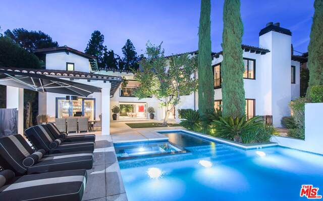 Contemporary Villa located behind gates and hedges just above the Sunset Strip sets a new standard of living by combining modern luxury and stylish living with a resort-like compound setting. Designed for entertaining on a grand scale, the indoor and outdoor living spaces open to pool, lawns and sculpture garden. Dramatic 2 story entry with sweeping staircase welcomes guests to grand living room and formal dining room. Exceptional quality in every finish from the gourmet kitchen with family room to screening room and more. Stunning master suite featuring luxurious dual baths and large custom designed walk-in closets. There is also gym, massage room and staff quarters. Gated motor court, 2 car garage and circular motor court offering plenty of parking. This home was masterfully crafted and built by Bret Barett offering every amenity imagined. Completely private and secluded in one of the most sought after locations.