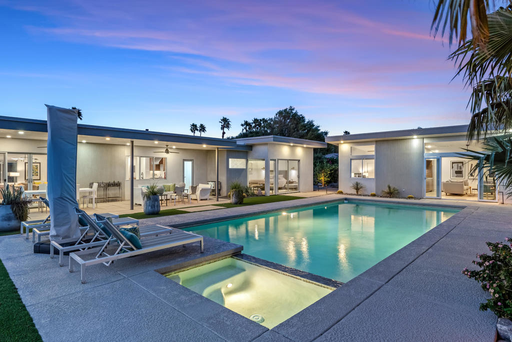 This sophisticated architectural standout was reimagined and completed in 2023 by award-winning architect Charles Austin of Configure 8 Studio. The 3-bedroom, 3-bathroom Palm Springs gem has 2300 SF of living space, which includes the newly added detached casita. The interiors & exteriors were meticulously reconstructed with an emphasis on the stunning views of the San Jacinto & Santa Rosa mountains - large clearstory windows & industrial-grade custom doors were used throughout. Exquisite attention to detail and high-end finishes make this a contemporary masterpiece - oversized terrazzo flooring, quartz countertops with waterfall edge, custom walnut & maple cabinetry, wire-brushed hardwood flooring, high-end kitchen appliance package, custom-built walnut desk workstation in the den, handmade architectural interior doors, custom floor moldings, tongue & groove ceiling, custom lighting detail, mid-century breeze block patio wall in the front facade. Huge custom pool & spa with screen logic automation app. 55'' smart TV in the primary bedroom, 75'' smart TV in the casita living room, and additional TVs in the den and casita bedroom. Professionally staged and fully furnished, the house also has Nest smart thermostat & Alexa Eco speaker. Minutes from world-renowned restaurants, nightlife, art galleries, shopping, hiking, and golf! Come enjoy this quintessential Palm Springs getaway!