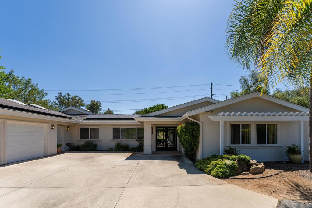 Spacious single story home on a large, usable lot in the desirable Green Valley neighborhood of Poway. The main residence offers five bedrooms with the option for a sixth, & four full bathrooms. Owned Solar & drought tolerant plants keep utility costs low. Enjoy an oversized kitchen & family room with soaring vaulted ceilings & abundant natural light—perfect for everyday living & entertaining. The primary suite includes a huge walk-in closet, slider to the backyard, private bathroom with separate tub, shower, & dual sinks. A separate guest space offers flexibility for a home office, studio, or potential ADU. The oversized three-car garage is equipped for a workshop. Step outside to a private backyard featuring a charming center courtyard, small sport court, garden beds, a dog run, & room for extra vehicle parking. Home has been freshly painted inside and outside. No HOA or Mello-Roos Fees. Poway Unified Schools - zoned for Painted Rock Elementary, Twin Peaks Middle, & Poway High School. Come see the potential!!