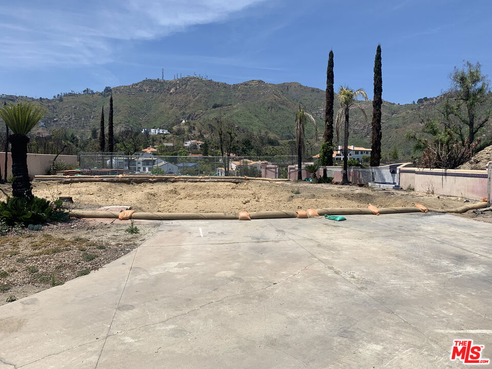 This half acre Malibu Parcel is a Palisades Fire rebuild and includes a pool, canyon and ocean views. The home consisted of 4 bedrooms and 3 bathrooms with 4,287 sq. ft. (per public records). Bring your developers or build your dream home. Located in the desirable Sea View Estates this home is approx. 10 to 12 minutes from pch. The property boundary portrayed in the images is only an approximation buyer is advised to perform a survey.